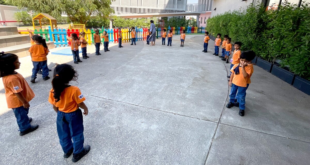 students playing in indoor ground at Adani International school