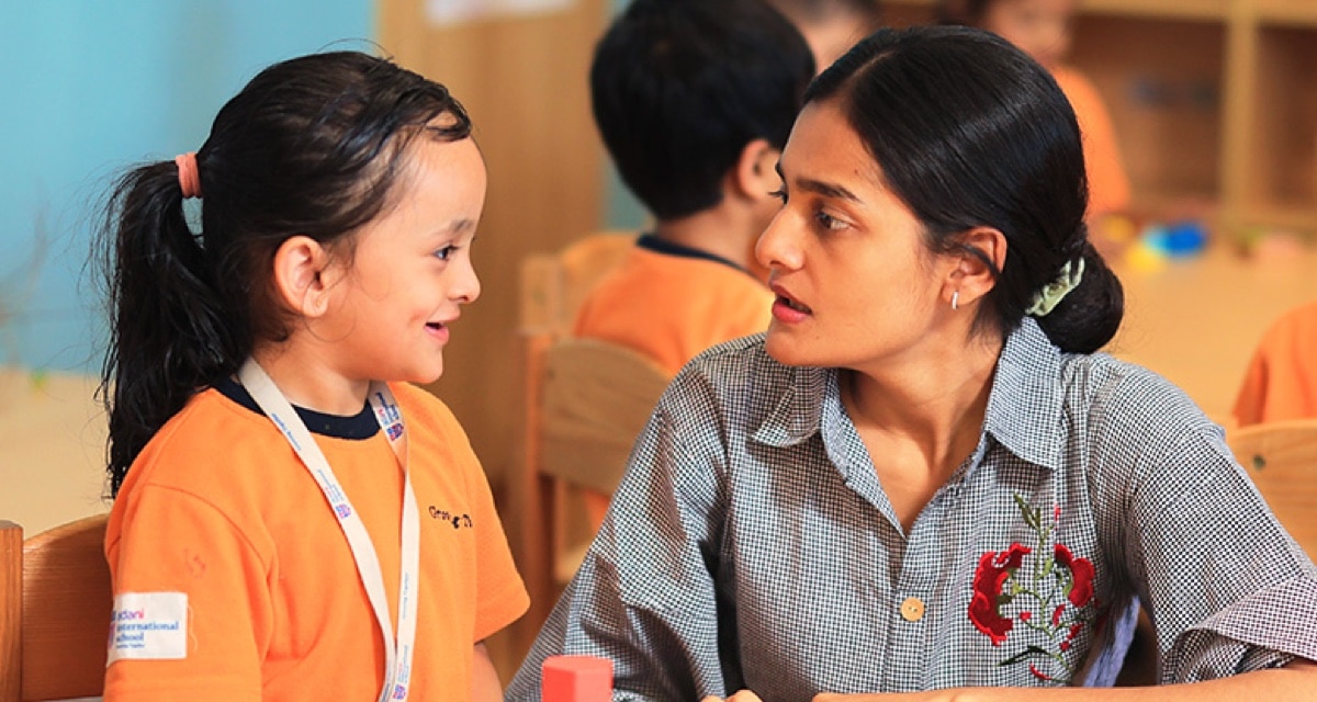a teacher with student at Adani International School