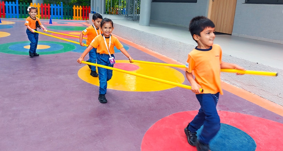 students playing in indoor ground at Adani International school
