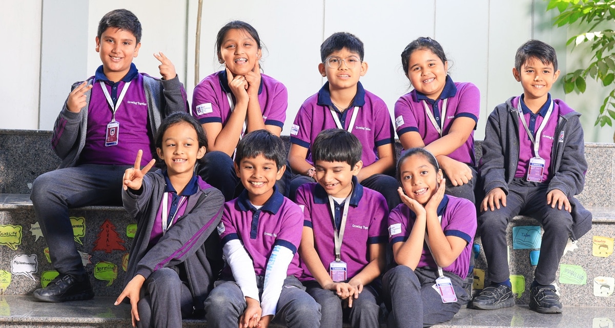 group of students sitting at bench at Adani international School