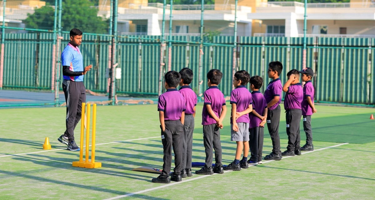 students in a net cricket ground at Adani International School
