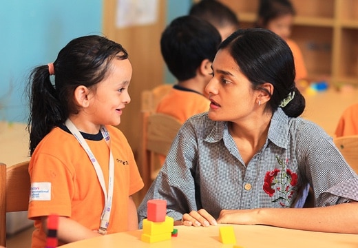 a teacher with student at Adani International School