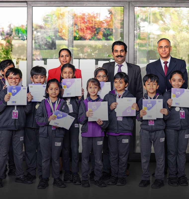 Students showing their participation certifications at Adani International School