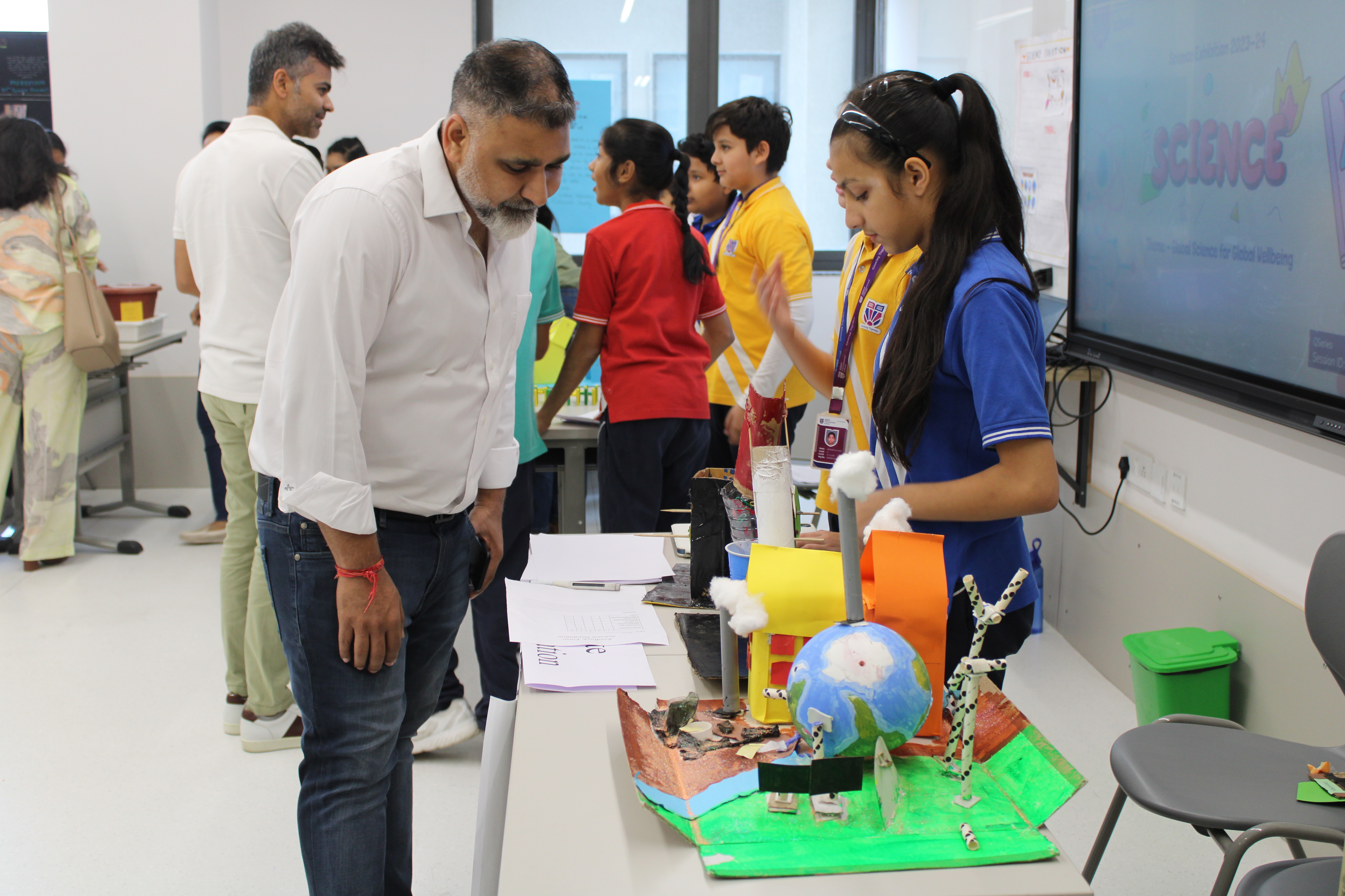 A turtle surronded by group of school kids at Adani International School