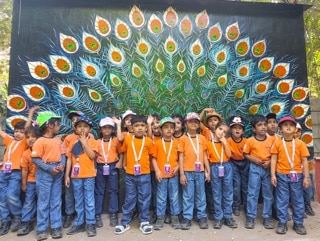 students standing in front of a wall at Adani International School