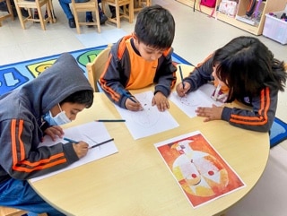 students drawing skethes in a art room