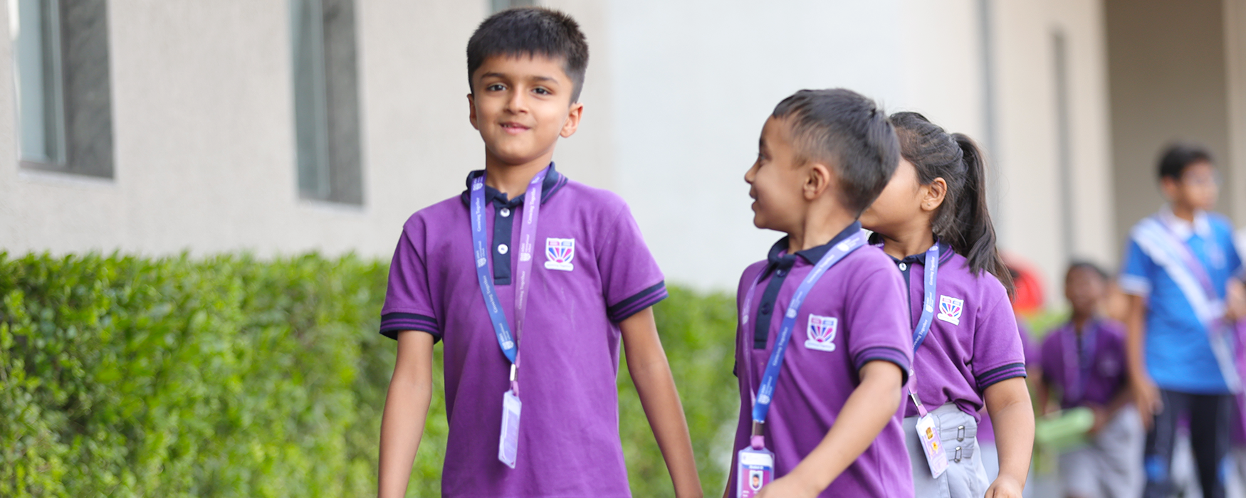 Two girls exploring world globe at Adani International School