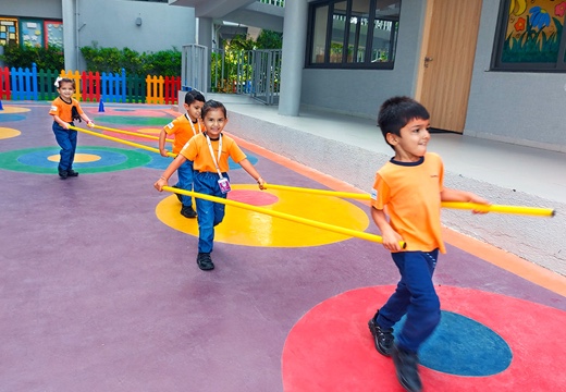 students playing in indoor ground at Adani International school