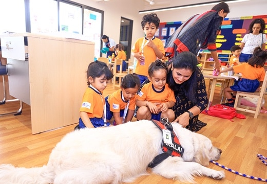 students & teacher with pet at Adani international School