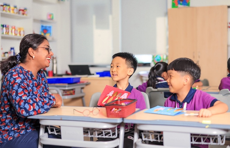 teacher interacting with students in a classroom