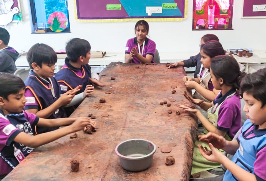 students learning clay modelling at Adani international School