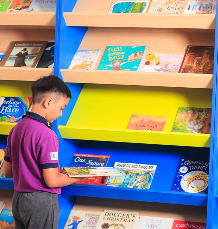 student in library at Adani International School