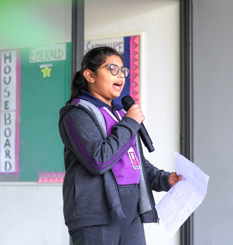 girl performing public speaking task at Adani international School