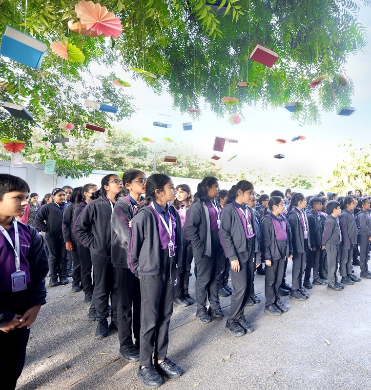 student standing in assembly at Adani international School