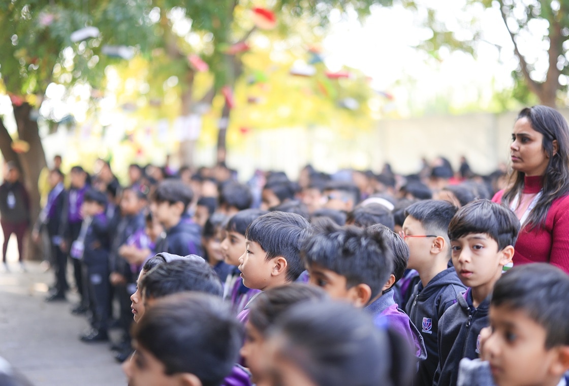 students standing at assembly at Adani International School