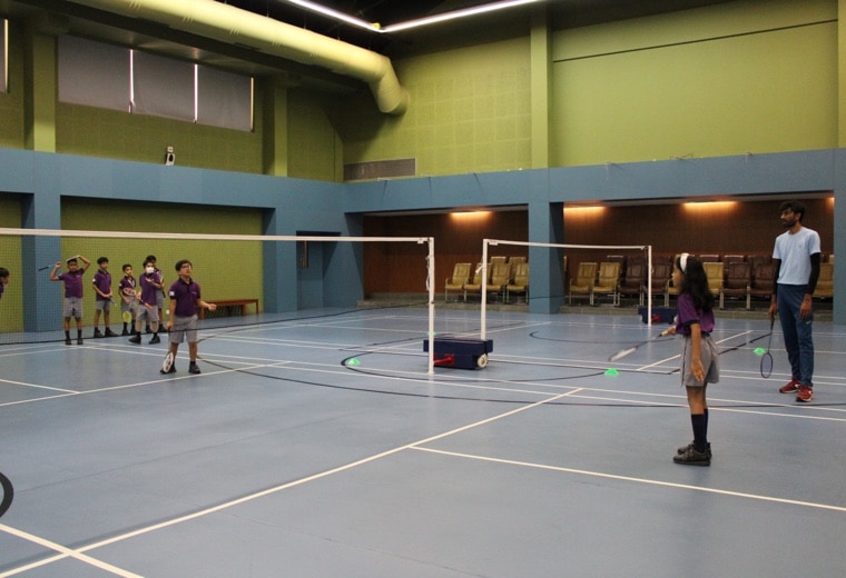 students playing badminton at Adani International School