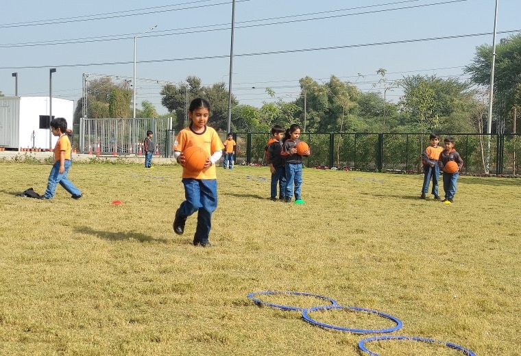 students playing bollyball at Adani International School
