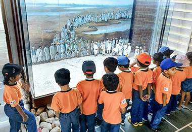 students looking at the portrait which is displaying in a showcase