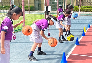 girls playing with the bollyball at Adani International School