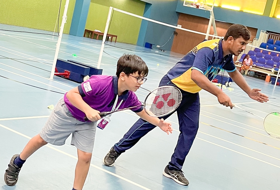 students playing badminton at Adani international School