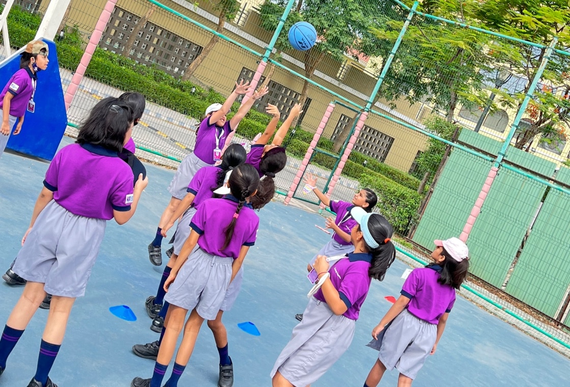 students playing basketball at Adani international School