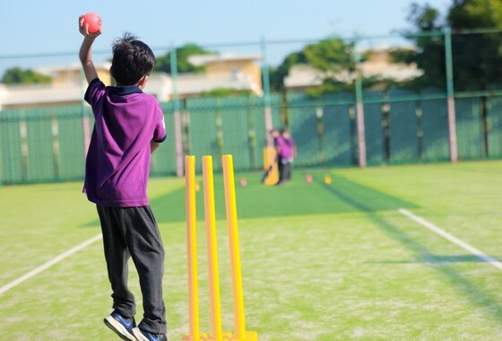students playing cricket at Adani international School
