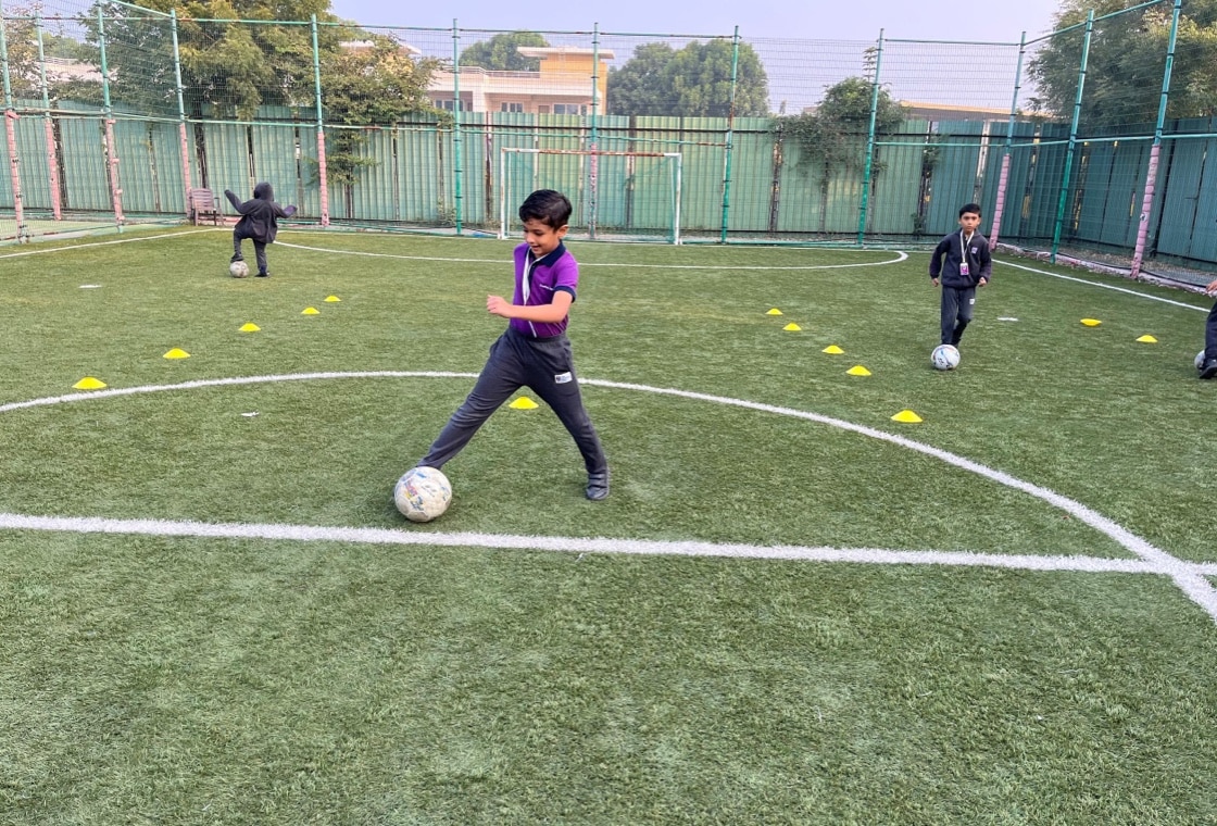 students playing football at Adani international School