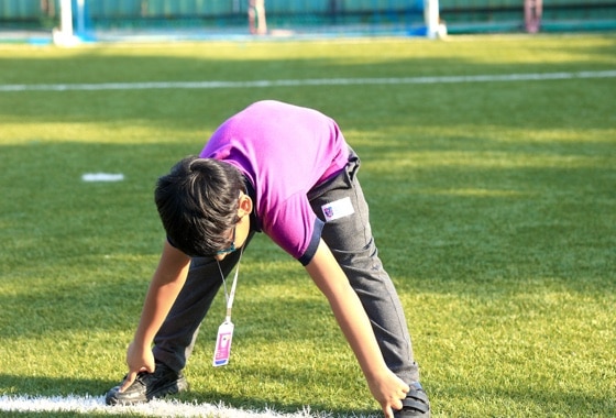 students doing yoga in playground at Adani international School
