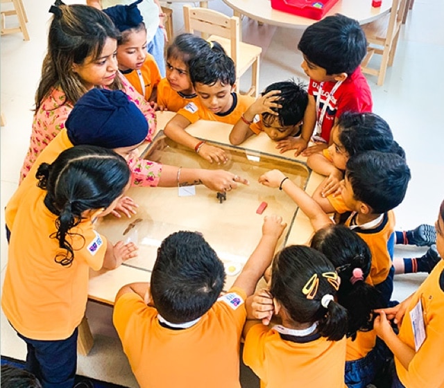 student with teacher playing game at Adani international School