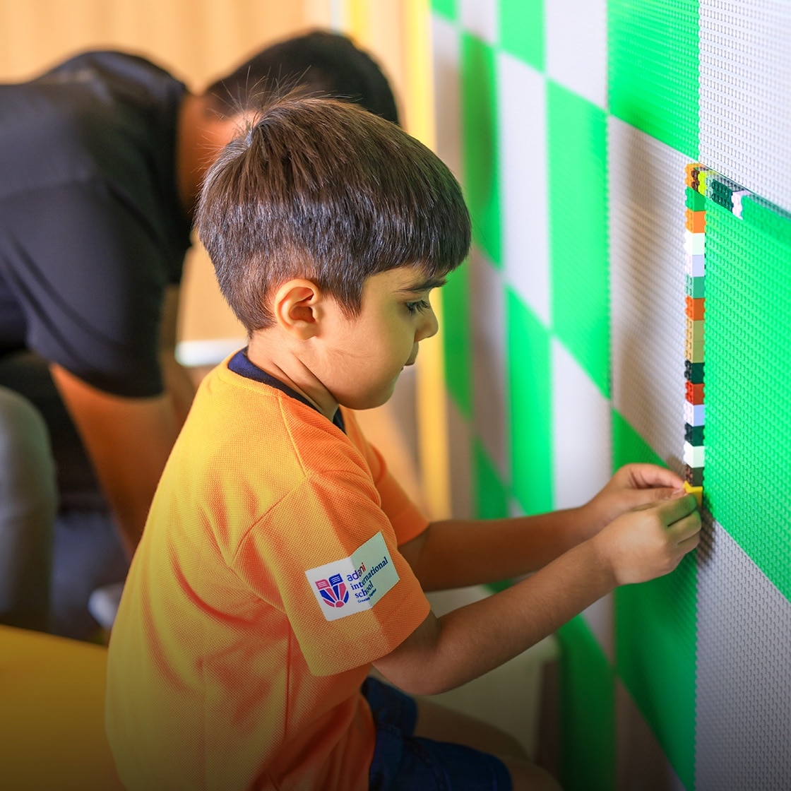 student doing craft activity at Adani international School