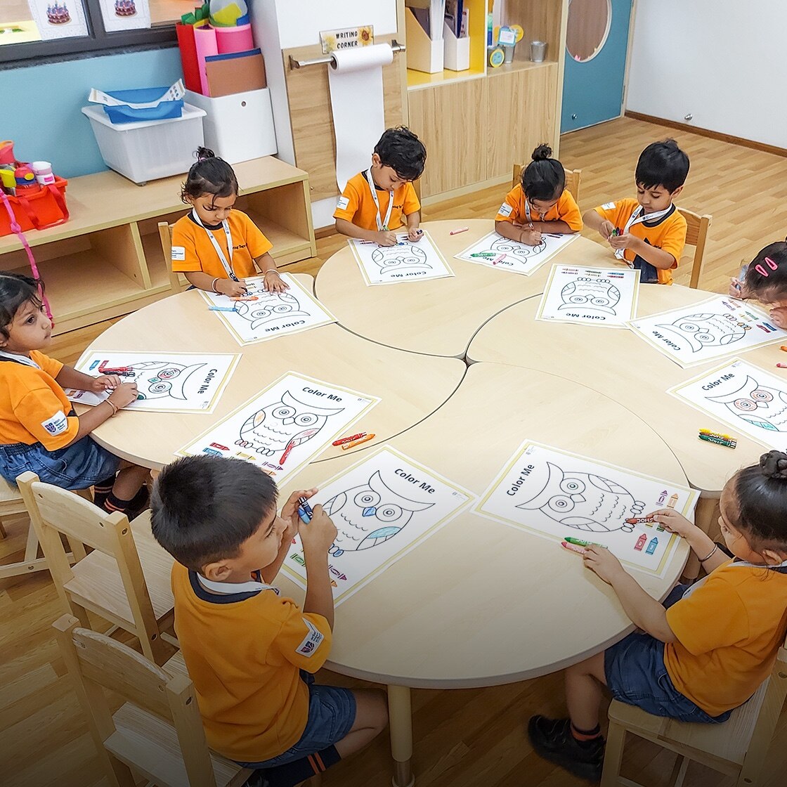 students sitting around a round table at Adani international School
