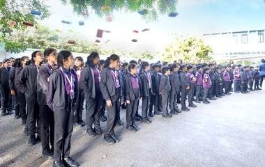 students standing in assembly at Adani International School